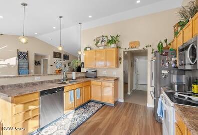 552 Spur Court Fernley, NV 89408 - Photo 18 of 46 a kitchen with stainless steel appliances granite countertop a sink a stove and a wooden floors