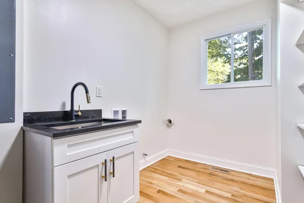 a kitchen with a sink cabinets and a window