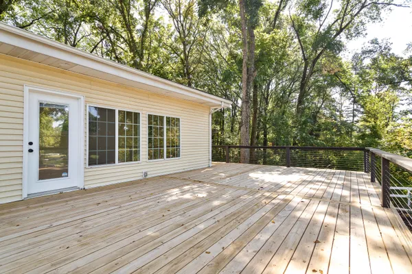 a view of a house with a wooden deck