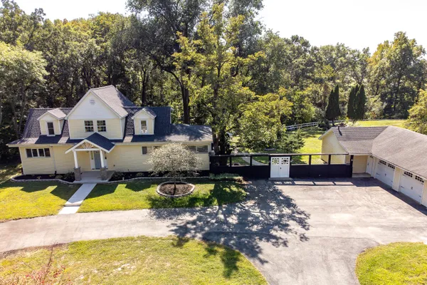 a view of a house with swimming pool and sitting area