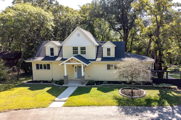 a front view of a house with swimming pool and porch