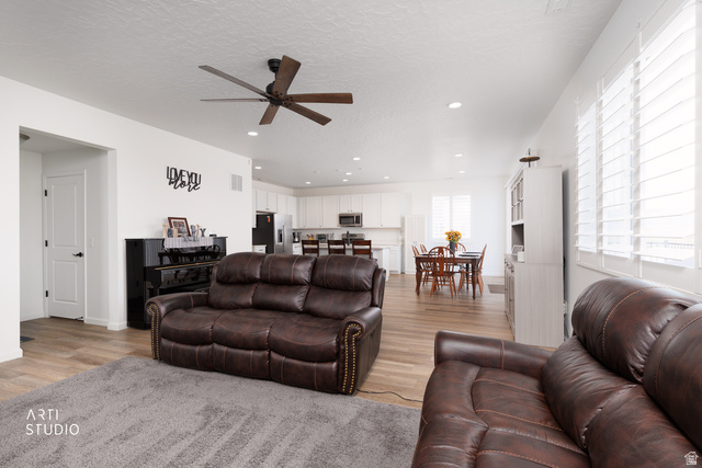 540 Lefty Lane Tooele, UT 84074 - Photo 13 of 48 Living room featuring ceiling fan, light wood-type flooring, recessed lighting, and a textured ceiling