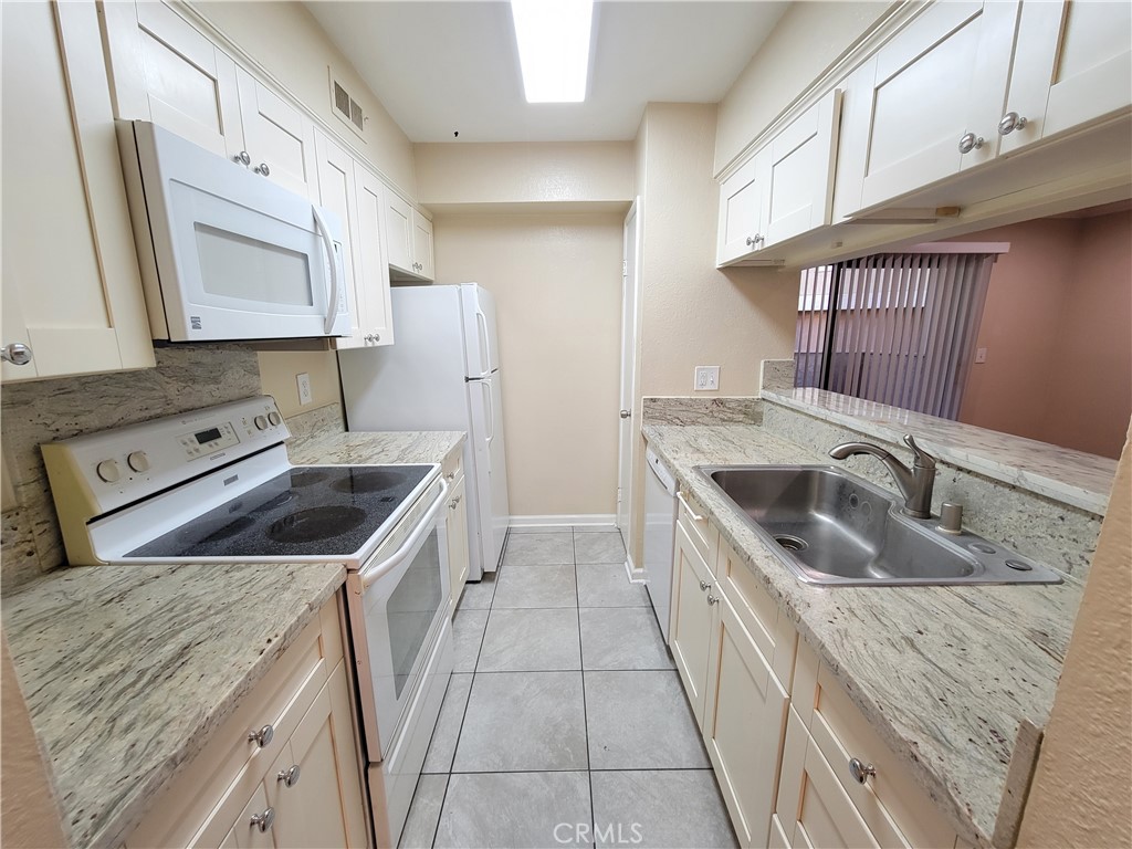 a kitchen that has a sink and a stove in it