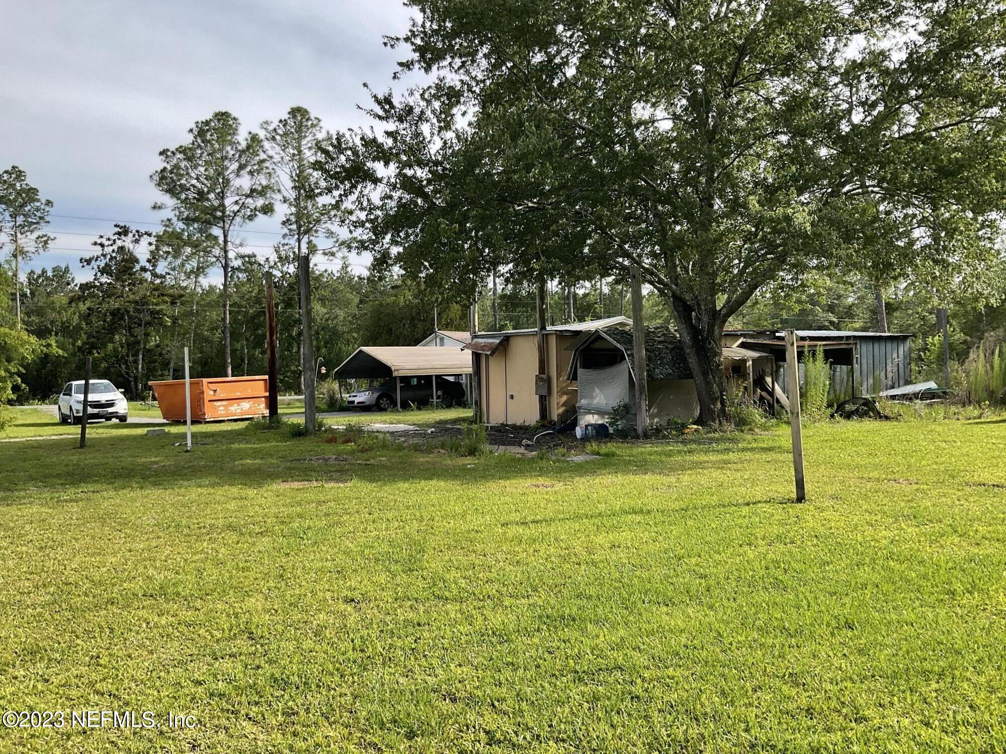 1365 US 90 Macclenny, FL 32063 - Photo 11 of 16 a view of a house with a big yard and large trees