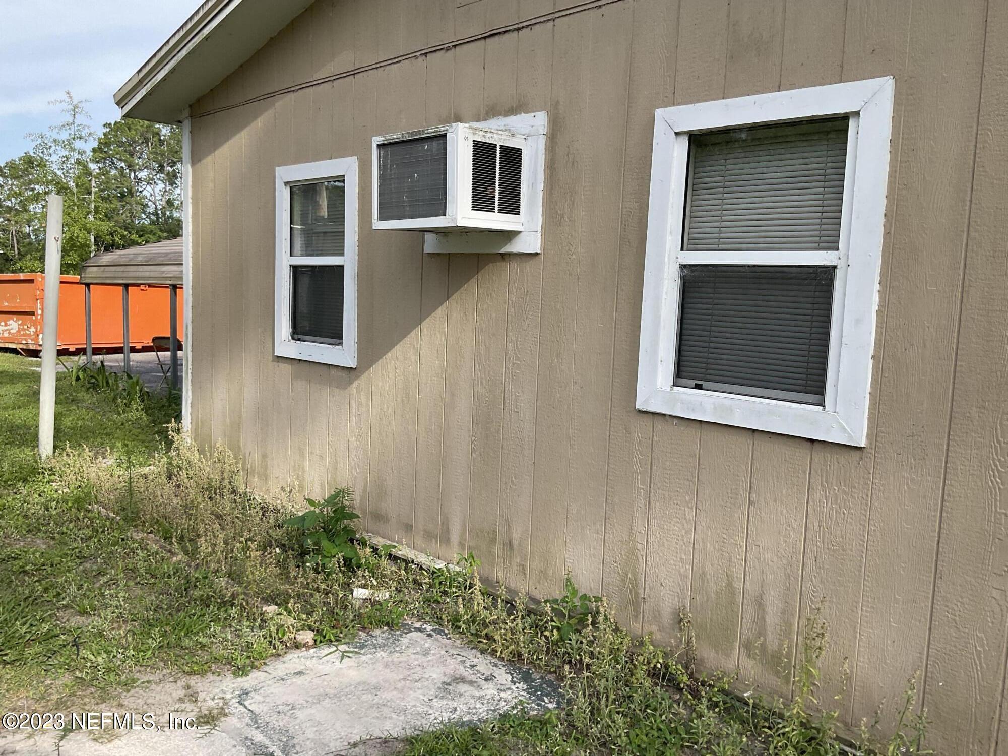 1365 US 90 Macclenny, FL 32063 - Photo 14 of 16 a front view of a house with a yard
