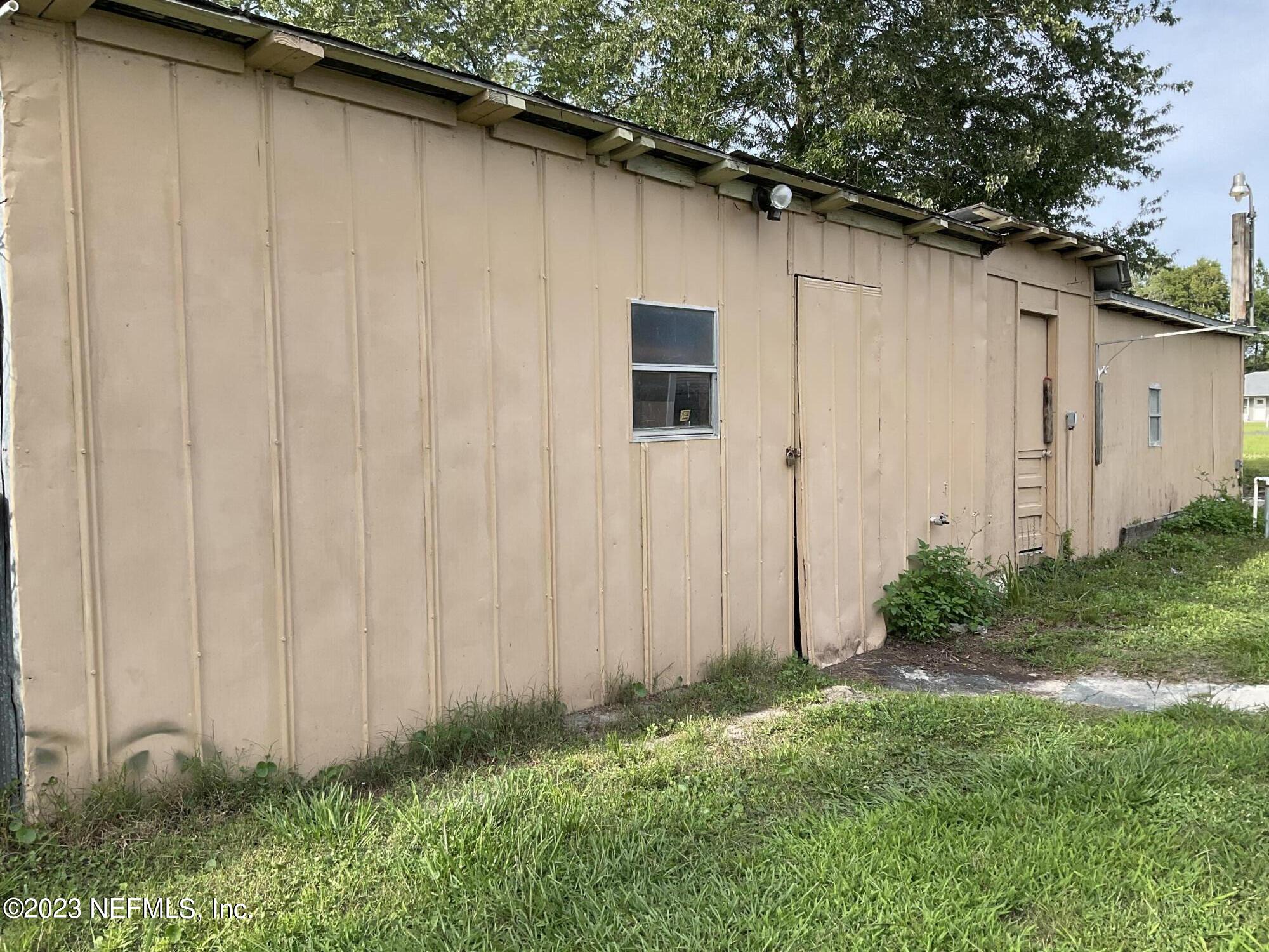 1365 US 90 Macclenny, FL 32063 - Photo 16 of 16 a backyard of a house with lots of green space and wooden fence