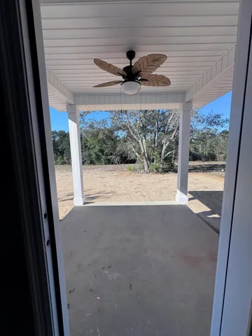 a view of a porch and floor to ceiling window