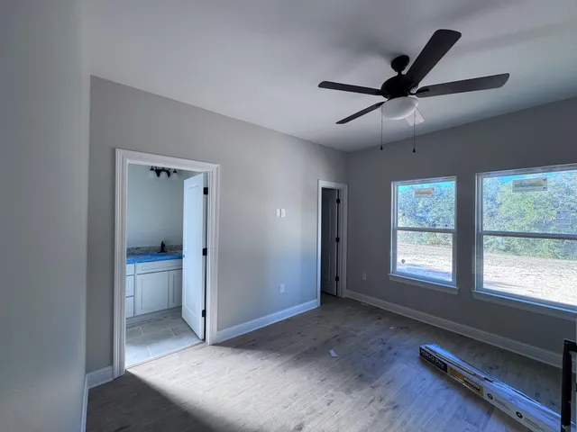 a view of a livingroom with a ceiling fan and window