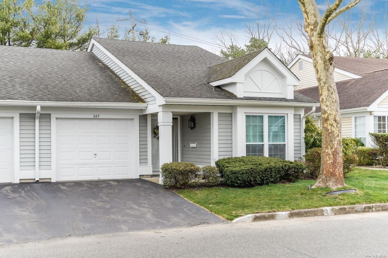 287 Glen Drive, Unit 287 Ridge, NY 11961 - Photo 1 of 1 front view of a house with a small yard