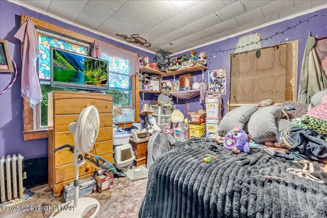 a bed room with a bed and a chair