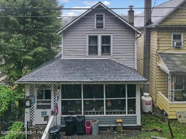 a front view of a house with a large window
