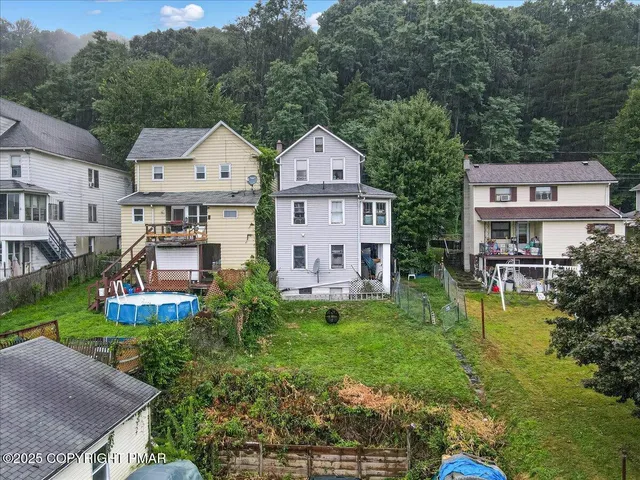 a aerial view of a house with swimming pool and garden