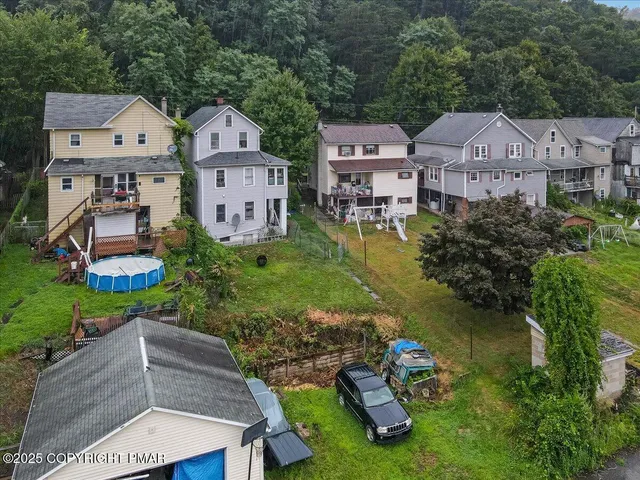 an aerial view of a building with outdoor space and street view