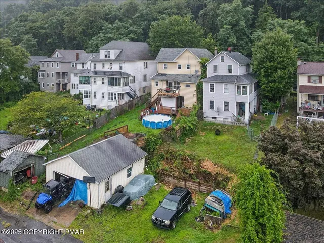 an aerial view of a house with yard swimming pool and outdoor seating