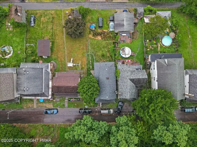 an aerial view of a residential houses with outdoor space