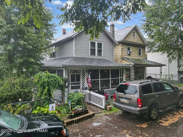 a front view of a house with a garden and plants