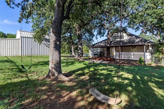 a backyard of a house with table and chairs