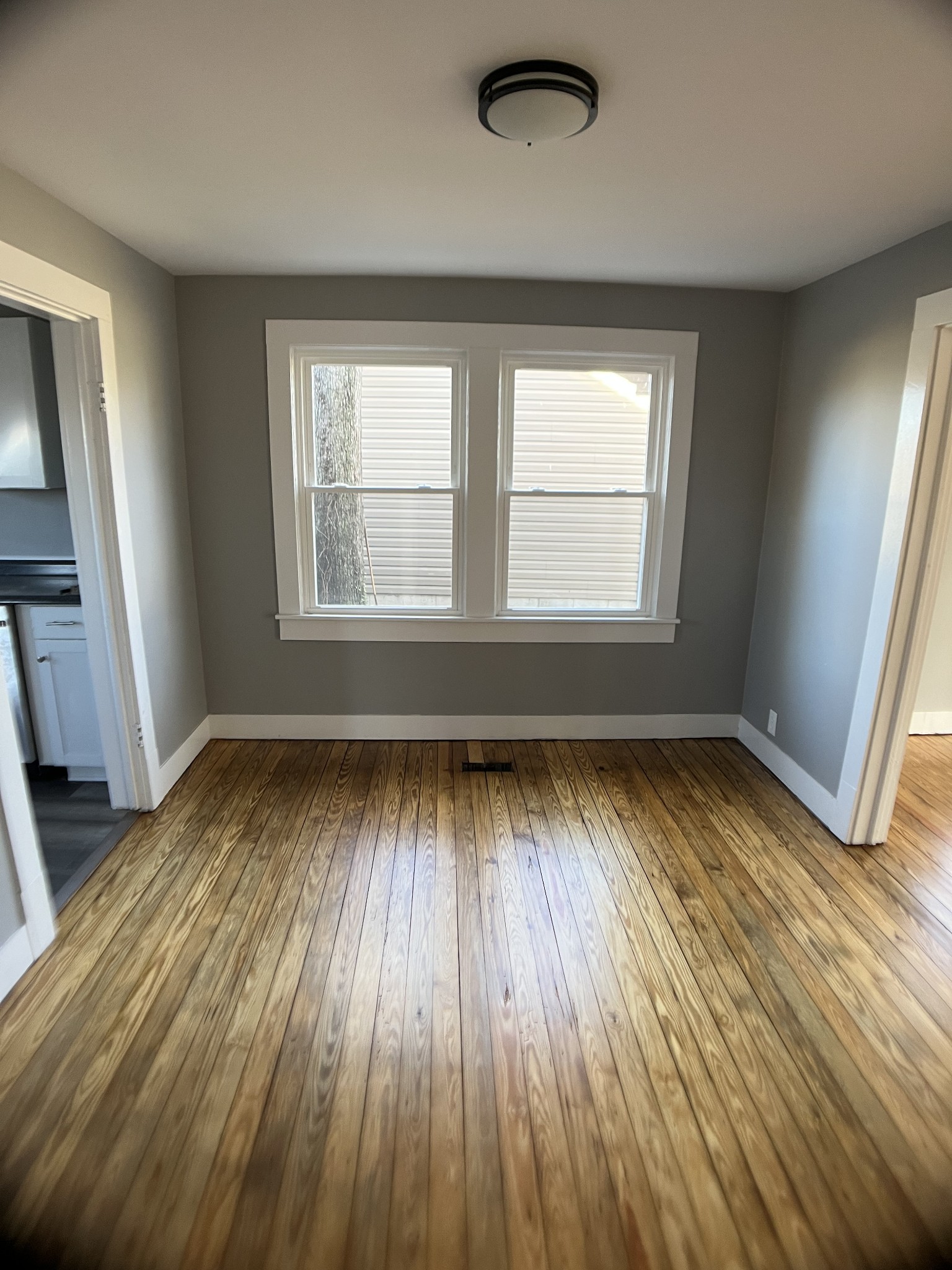 124 Arnold Lane Murfreesboro, TN 37127 - Photo 8 of 14 an empty room with wooden floor and windows