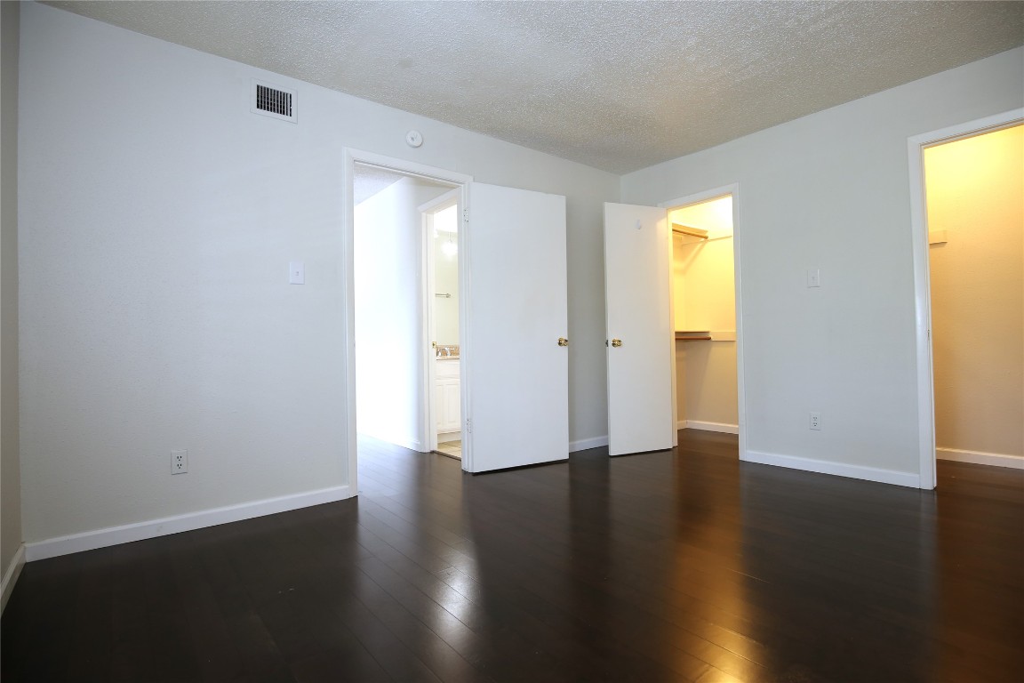 8210 Bent Tree Road, Unit 257 Austin, TX 78759 - Photo 12 of 20 a view of an empty room with wooden floor and a window