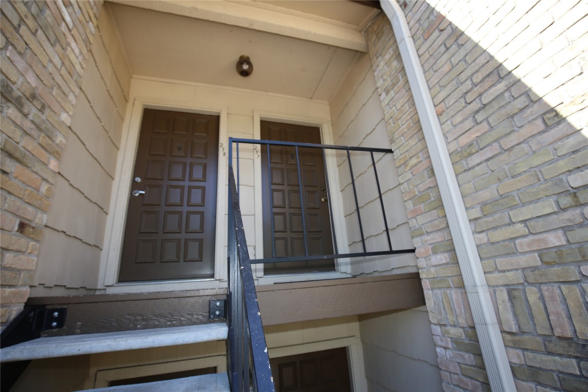 8210 Bent Tree Road, Unit 257 Austin, TX 78759 - Photo 2 of 20 a view of balcony with wooden floor and white wall