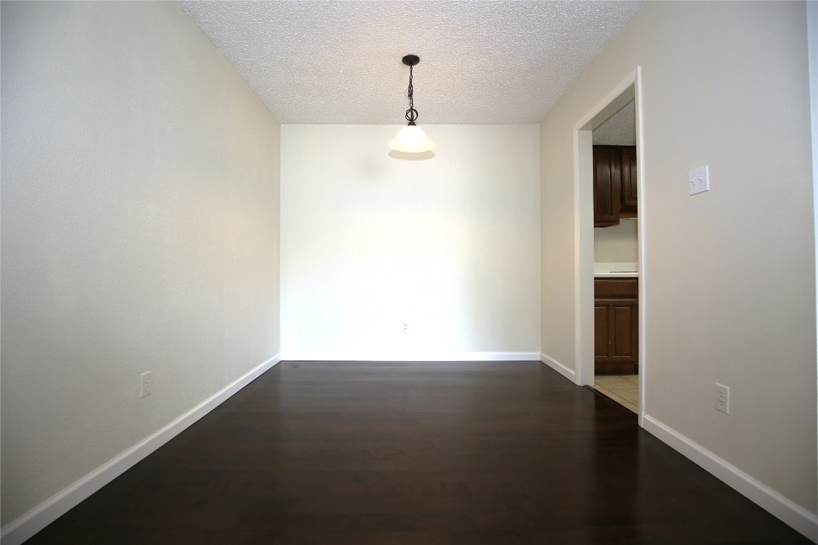 8210 Bent Tree Road, Unit 257 Austin, TX 78759 - Photo 5 of 20 an empty room with wooden floor and windows
