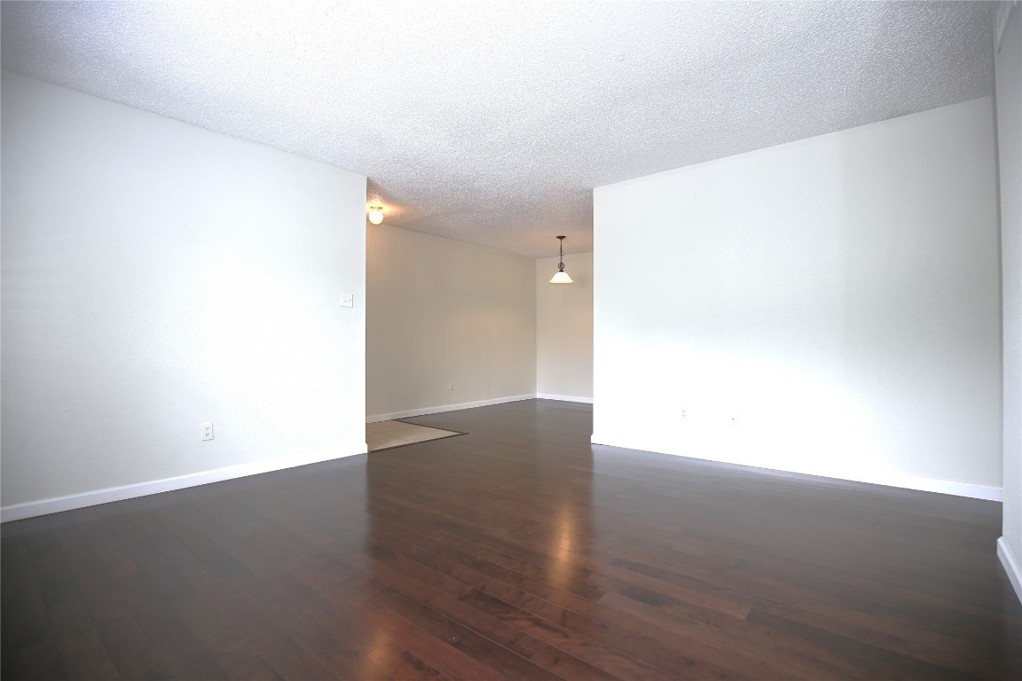 8210 Bent Tree Road, Unit 257 Austin, TX 78759 - Photo 10 of 20 a view of an empty room with wooden floor
