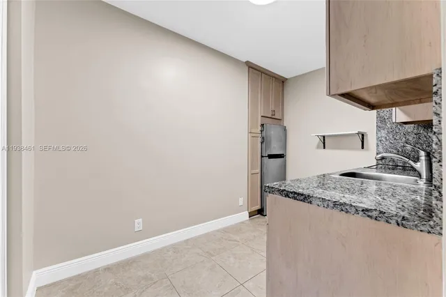 a kitchen with stainless steel appliances granite countertop white cabinets and a sink