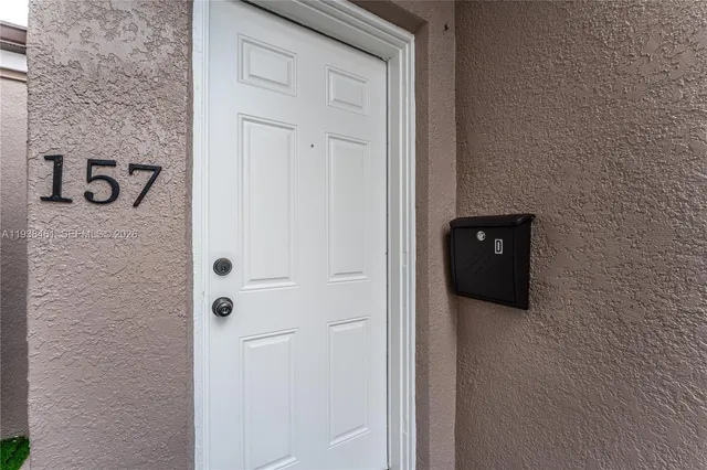 a view of a kitchen with dishwasher and white cabinets