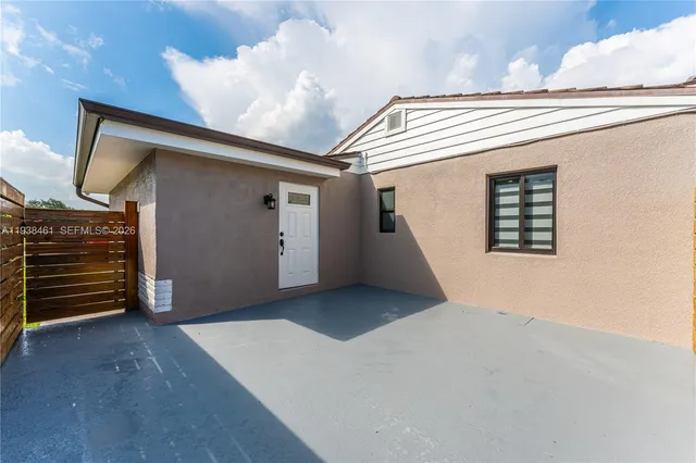 a kitchen with granite countertop a sink stainless steel appliances and white cabinets