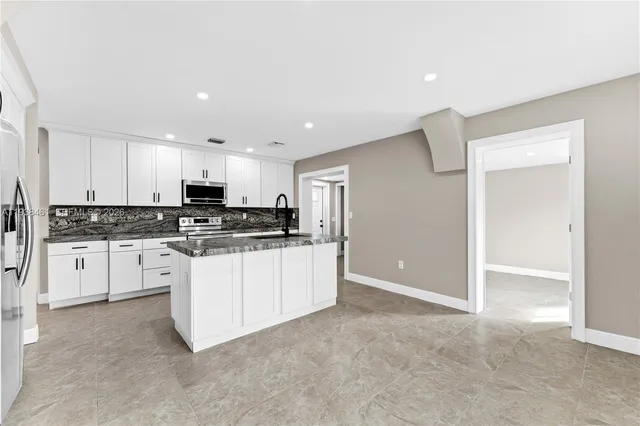 an aerial view of a swimming pool patio and outdoor seating