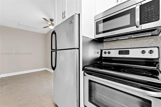 a view of kitchen with appliances and cabinets
