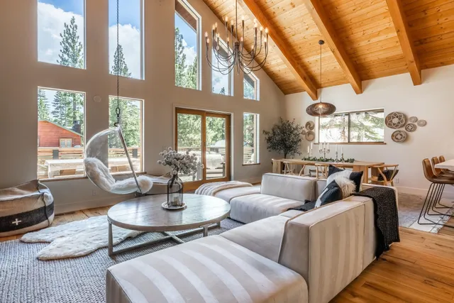 a living room with couches a fireplace and next to a window