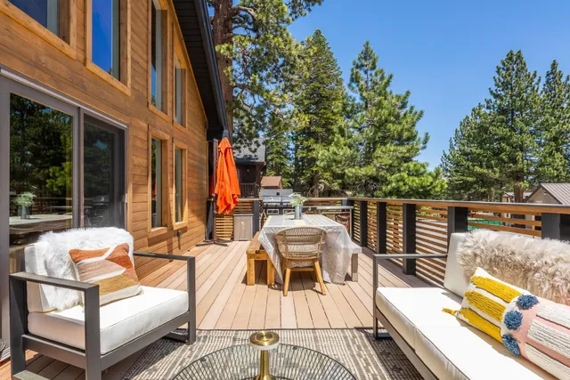 a view of a roof deck with couches and wooden floor