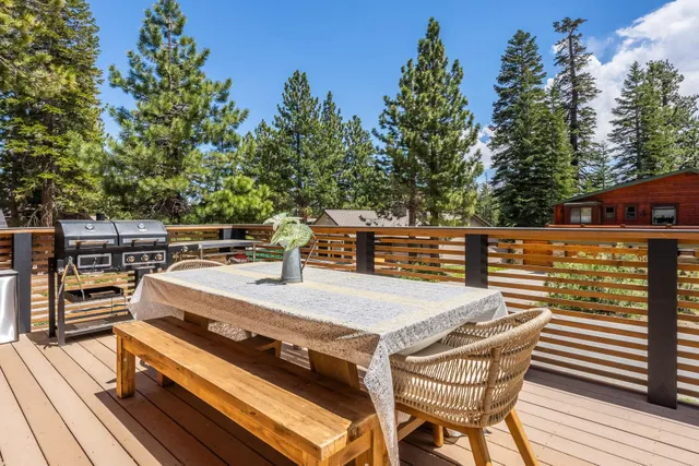 a view of a balcony with table and chairs