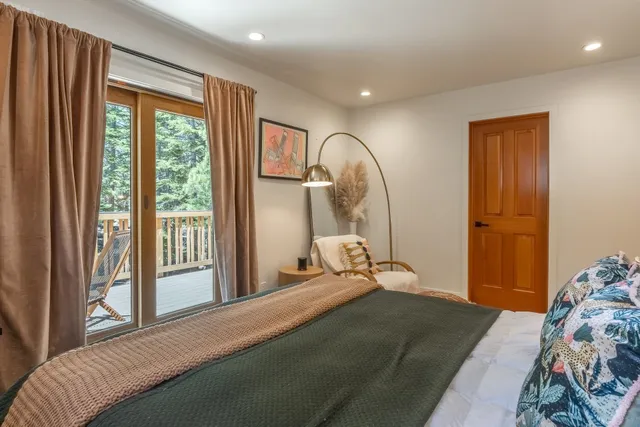 a bedroom with a bed and a large window