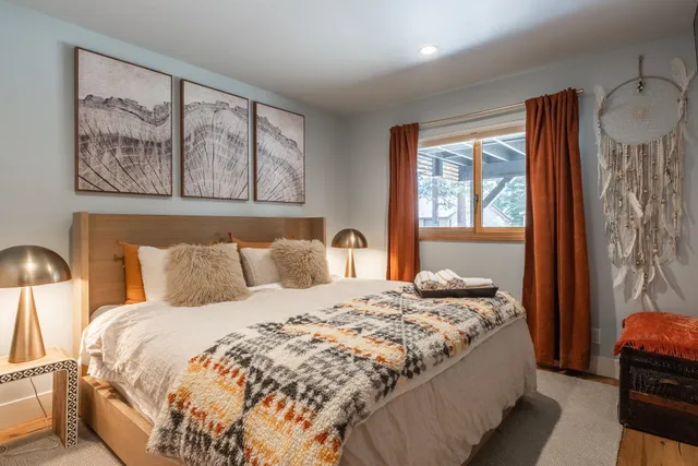 a bedroom with a large bed and a window