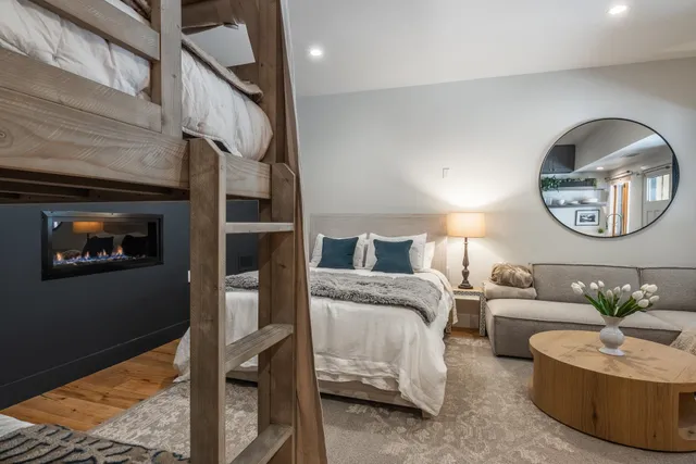 a bedroom with a bed couch and window