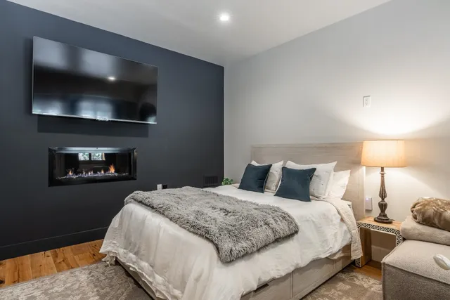 a bedroom with a bed and a flat screen tv