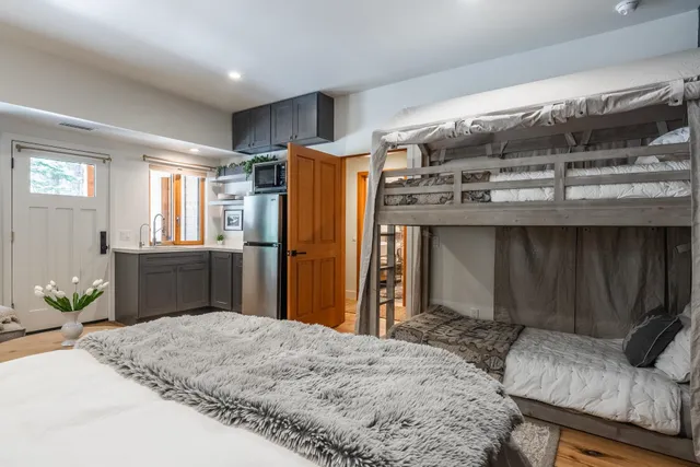 a kitchen with stainless steel appliances kitchen island granite countertop a refrigerator and a sink