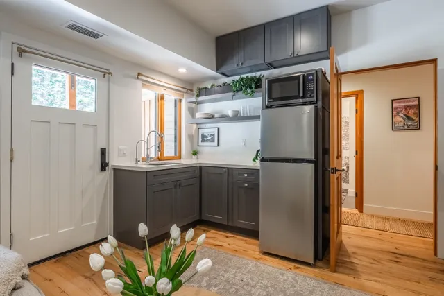 a kitchen with stainless steel appliances granite countertop a refrigerator and a sink
