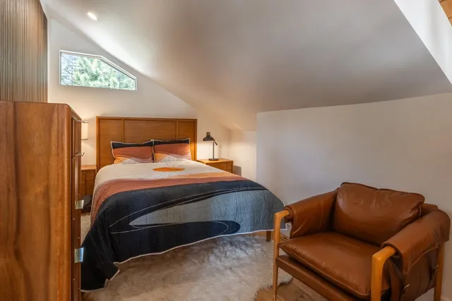 a bedroom with a bed and cupboard