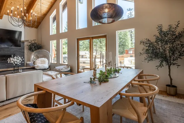 a kitchen with a table chairs and living room