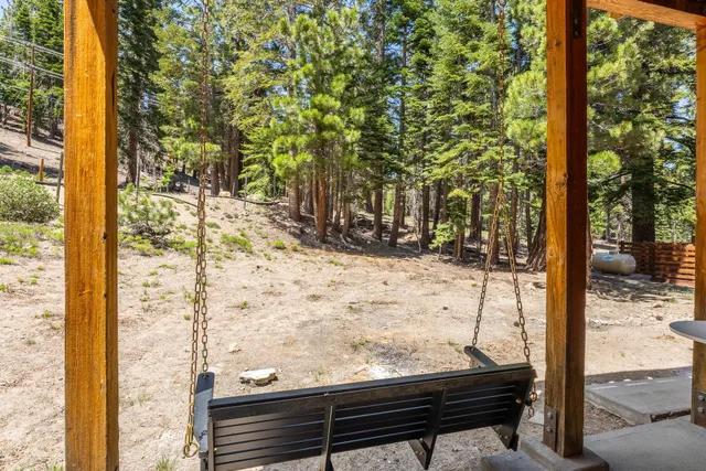 a view of a yard with wooden fence