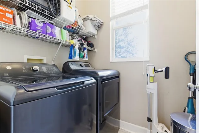 a view of a big house with a big yard and large trees