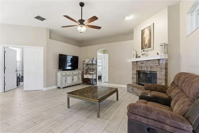 a view of a dining room with furniture a rug and wooden floor