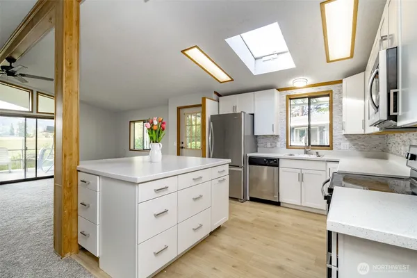 a kitchen with a stove a sink and a refrigerator