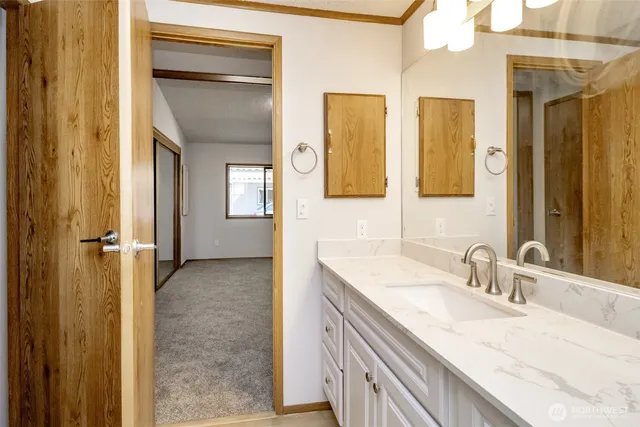 a bathroom with double vanity sinks and a mirror