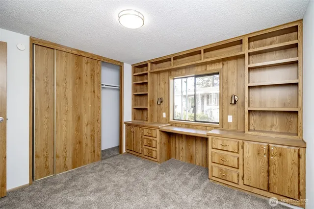 a view of walk in closet with empty shelves