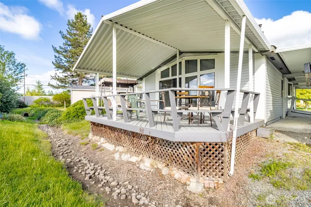 a view of a house with backyard and sitting area