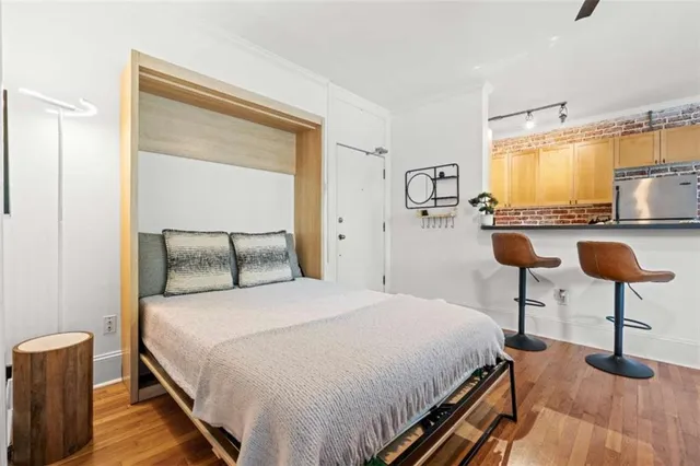 a bedroom with a bed and chandelier